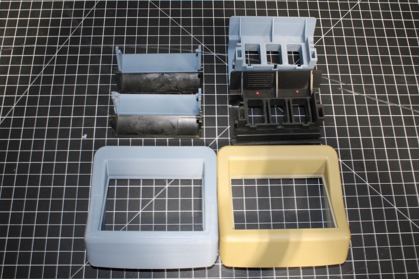 Printed enclosure prototypes laid out on a cutting mat
