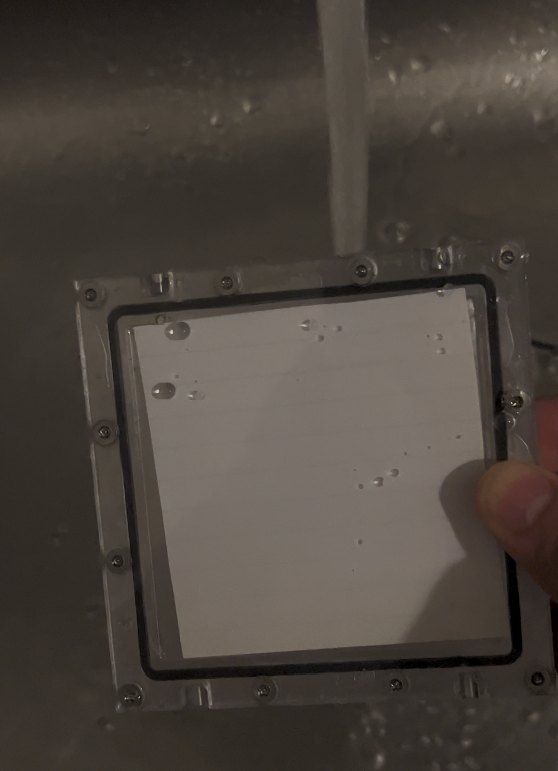 Guard under running water during a washdown test
