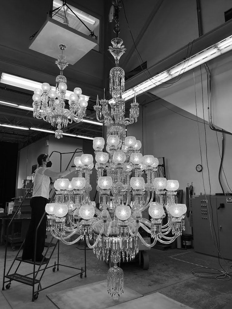 Multi-tier chandelier being assembled in the shop