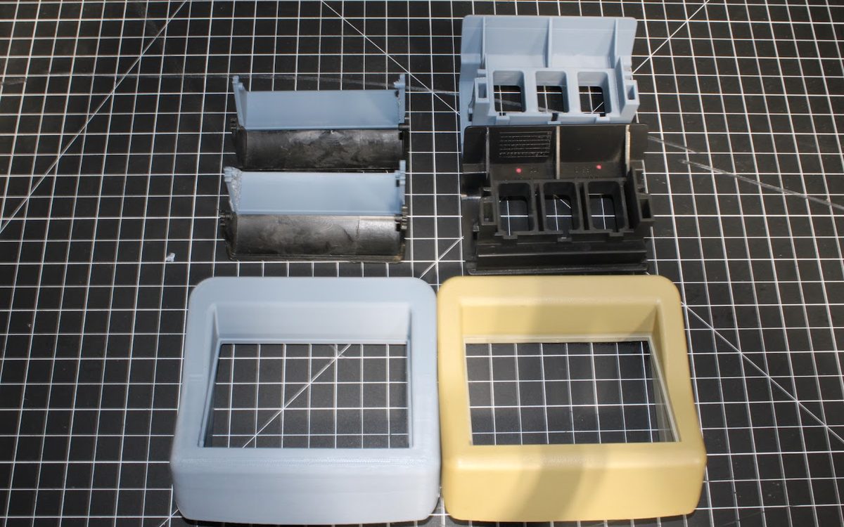 Worn plastic parts beside 3D printed replacements made from a 3D scan