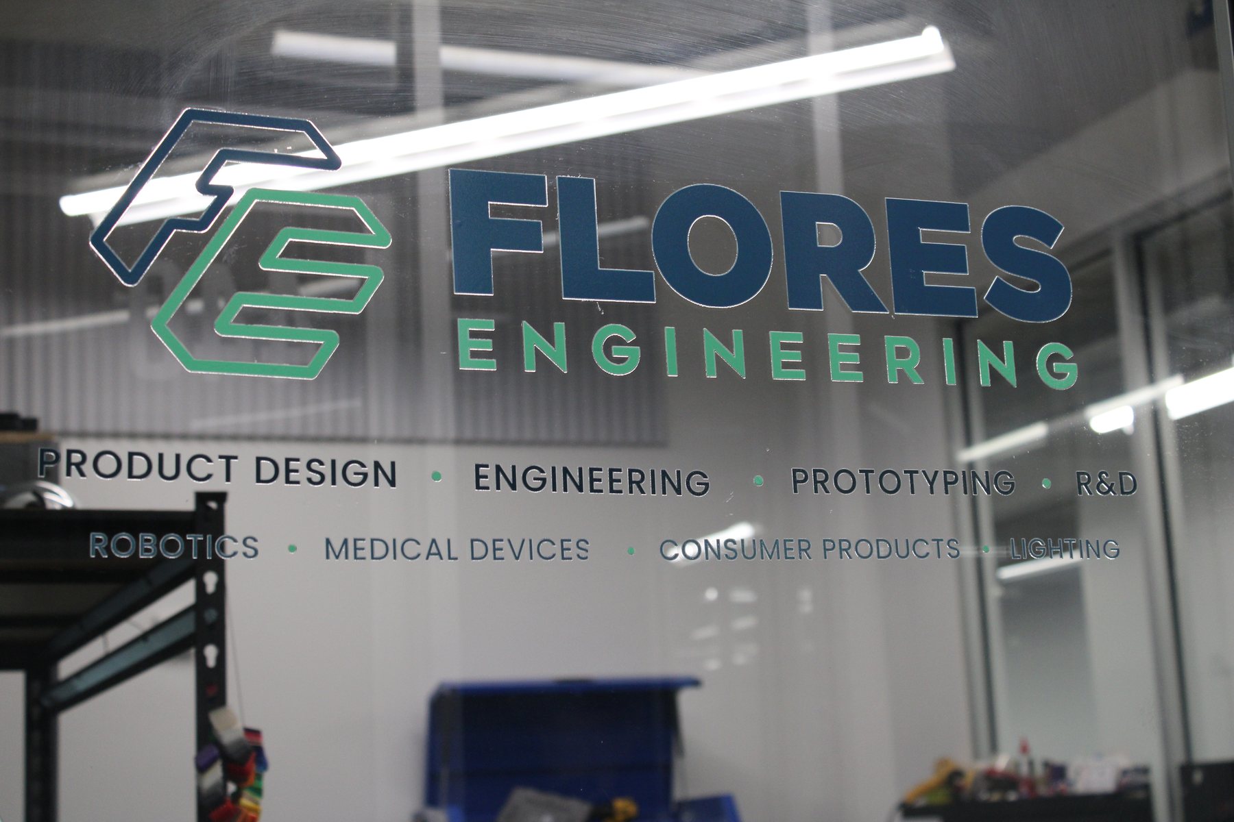 Flores Engineering sign on the glass wall of Suite 430 in Kearny, NJ