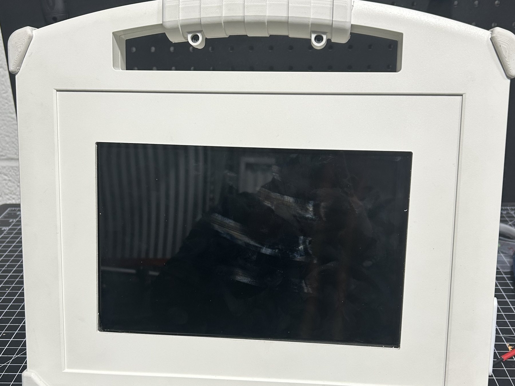 Rugged handheld medical monitor housing on the lab bench